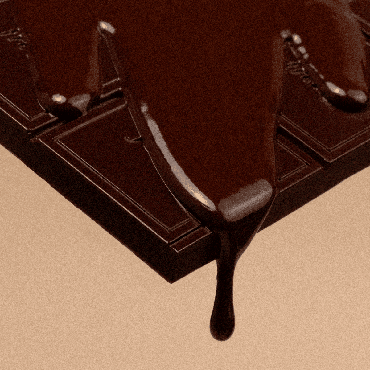 Close-up of a chocolate bar with a piece being lifted, showing a rich brown color.